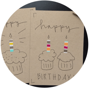 hand drawn cupcakes card with a caption happy birthday and colored candles