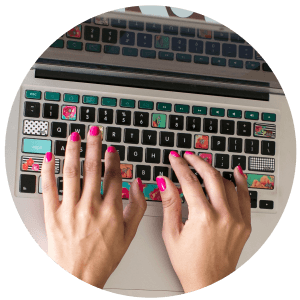 huge round cropped image of hands typing on a floral keyboard