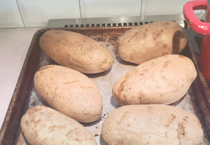 image of baked potatoes in a baking pan on top of sink top